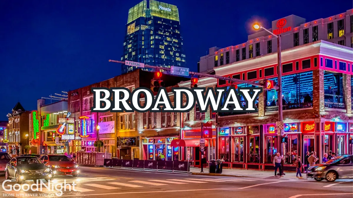 A vibrant nighttime street scene with neon signs, bustling sidewalks, pedestrians, and lively buildings. The image radiates energy, highlighting Nashville’s famous nightlife and social atmosphere.